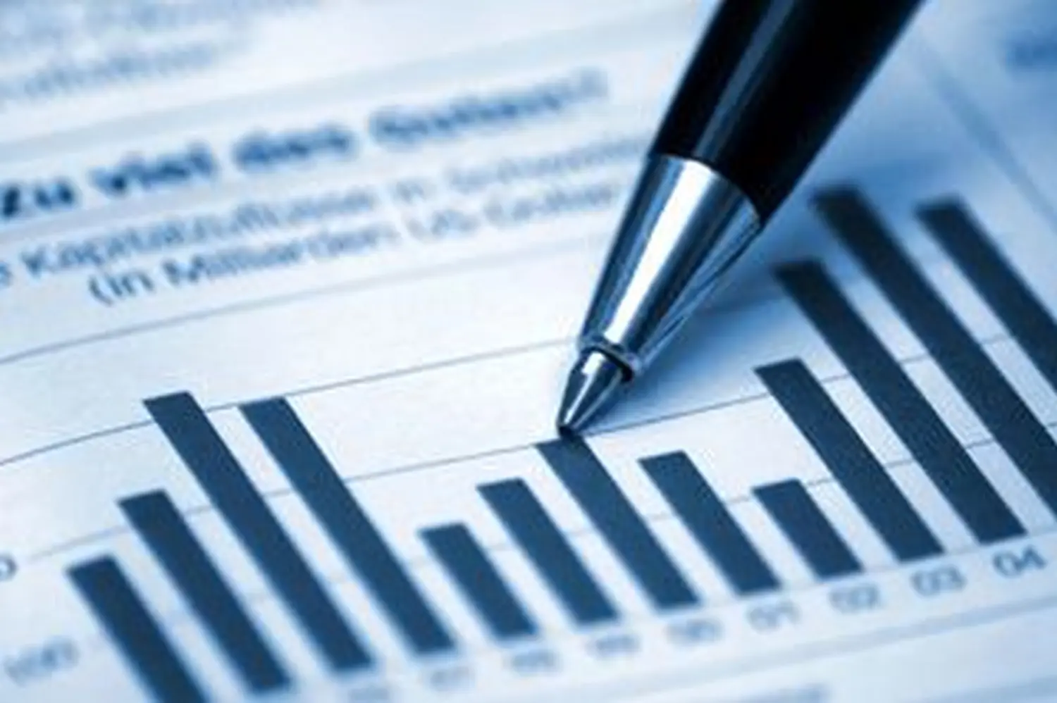 Pen on chart or graph paper financial account statistics and business data concept